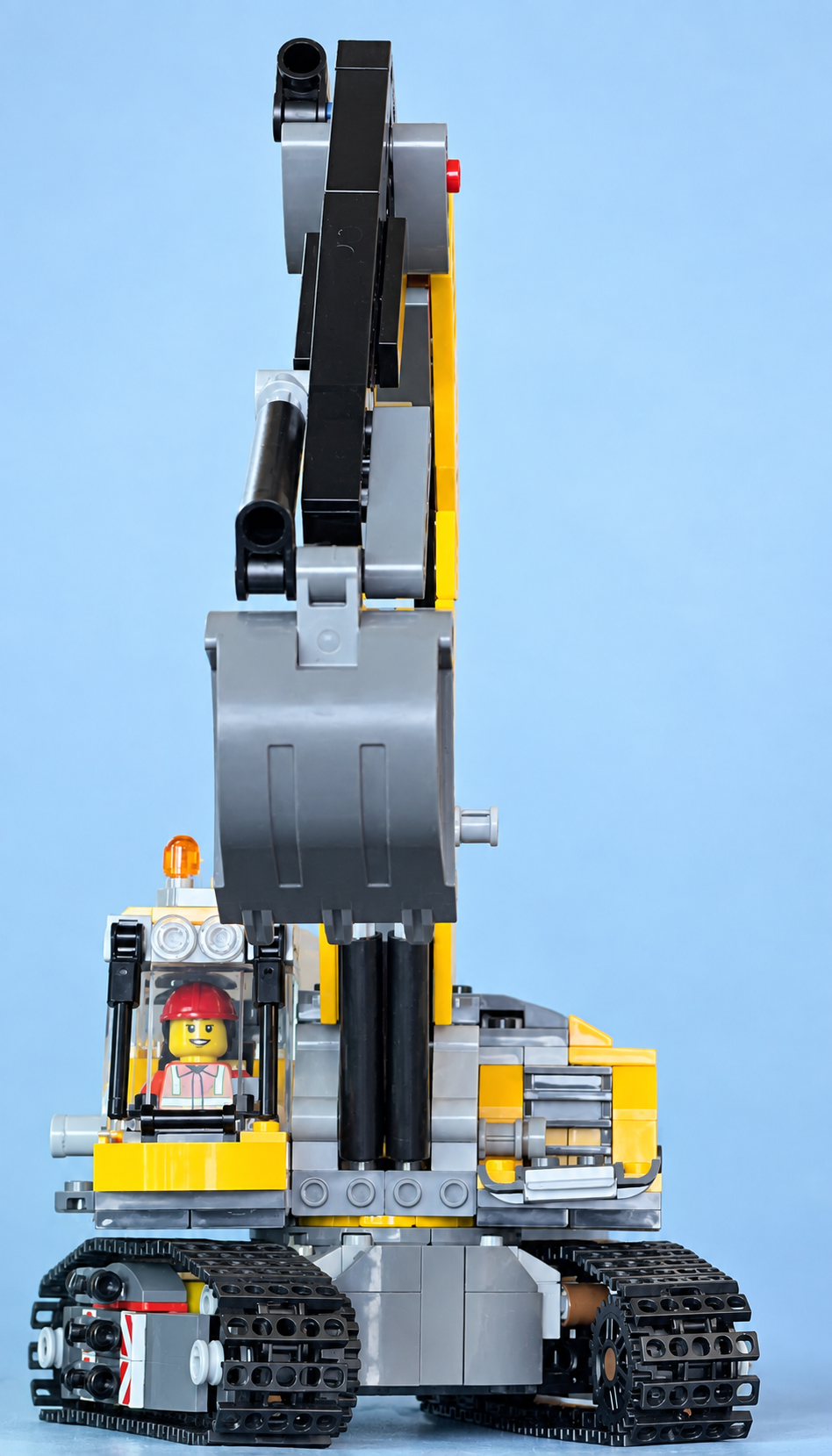 Professional studio photograph of Skye's LEGO excavator with a minifigure operator